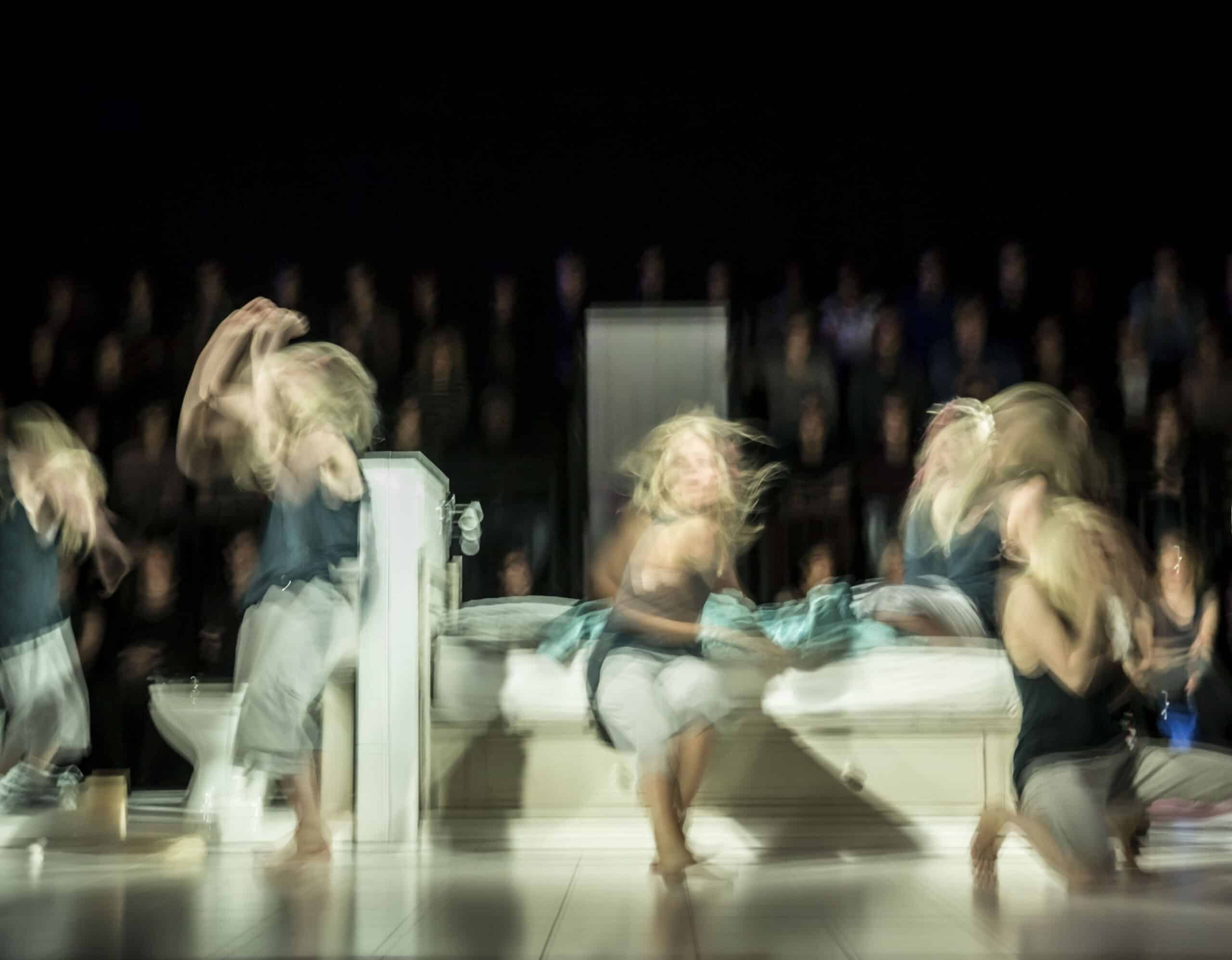 Long exposure of performers on stage, mid-performance
