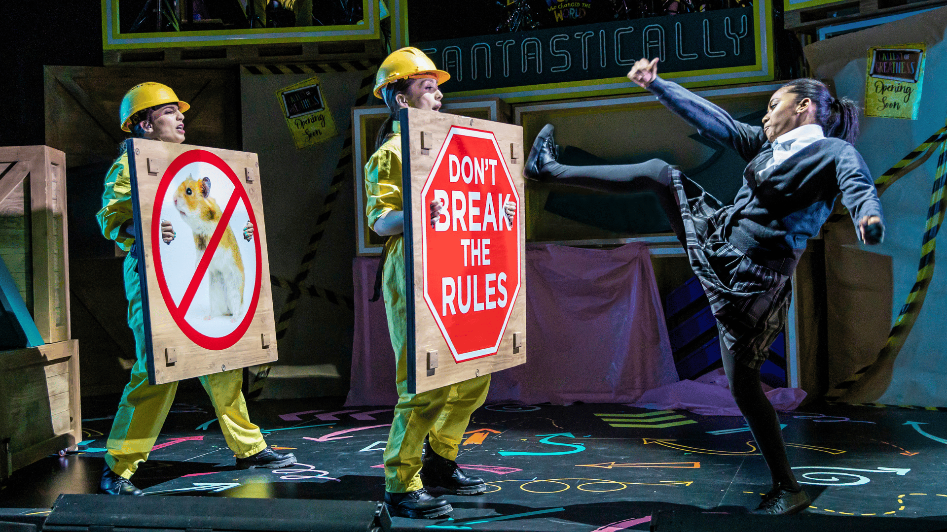 2 characters dressed as builders are holding signs, with one sign reading 'DON'T BREAK THE RULES'. Another character is looking angry and going to kick the sign.