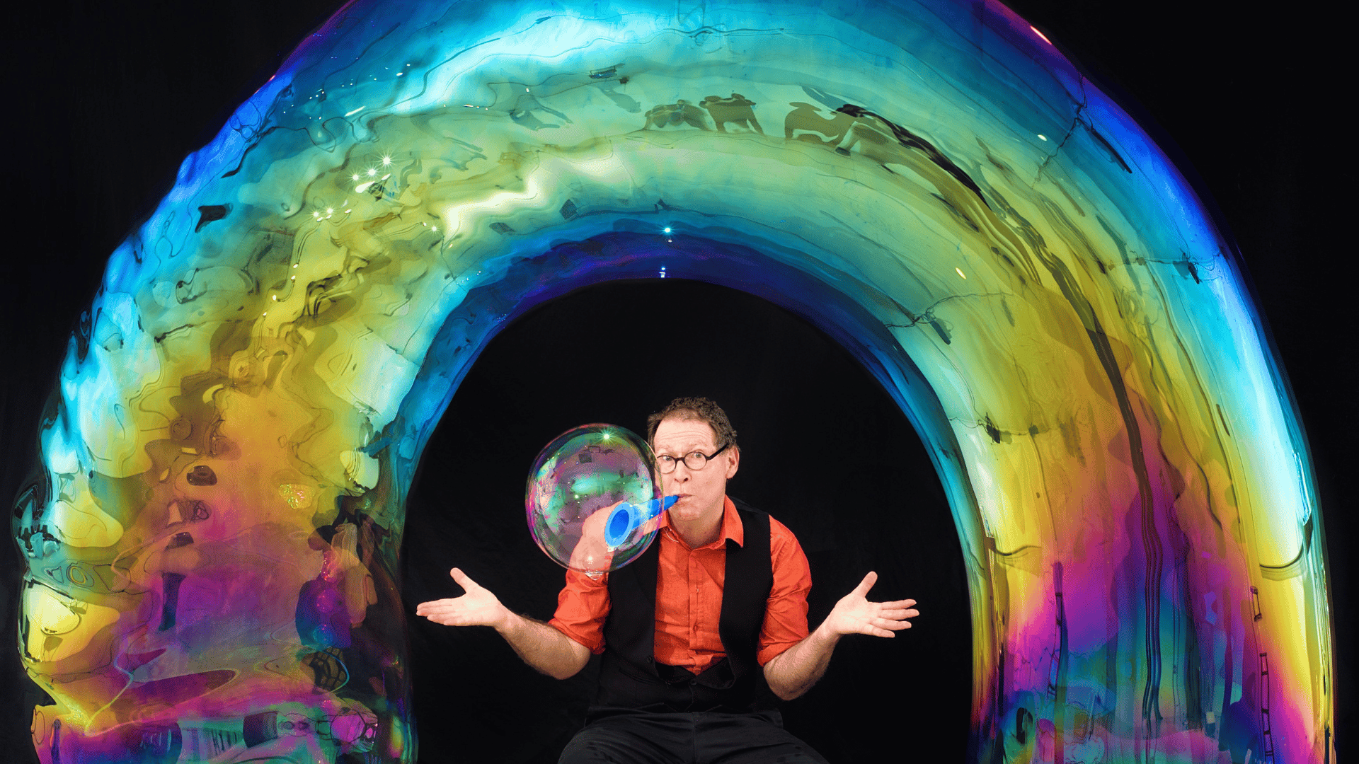 The Amazing Bubble Man has created a giant rainbow bubble over his head